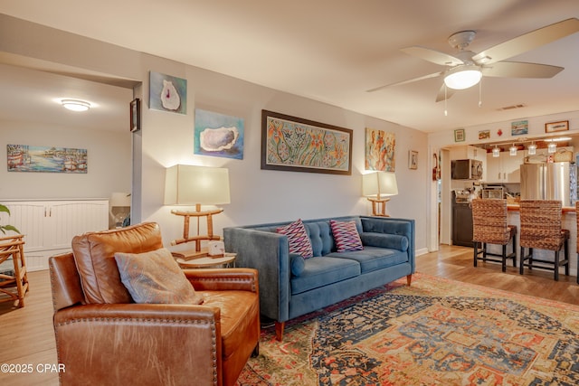 5821 S Lagoon Dr, Panama City, FL 32408 - living area featuring light wood finished floors and a ceiling fan