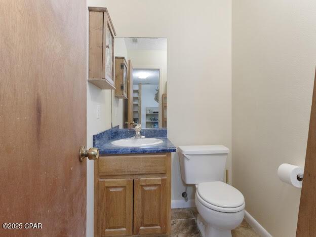 2921 Ambus Ln, Chipley, FL 32428 - half bath with vanity, toilet, baseboards, and tile patterned floors