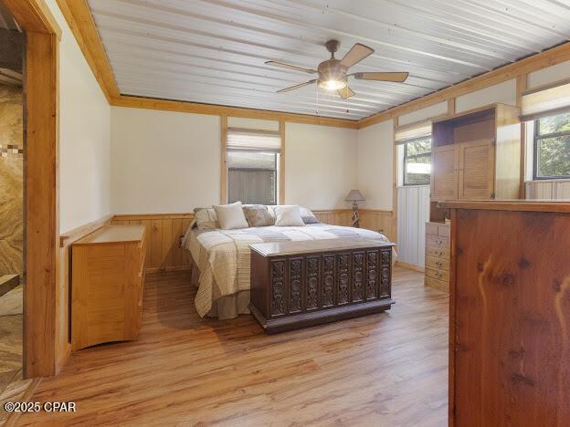 2921 Ambus Ln, Chipley, FL 32428 - bedroom featuring wainscoting, wood ceiling, light wood-style flooring, ornamental molding, and wood walls