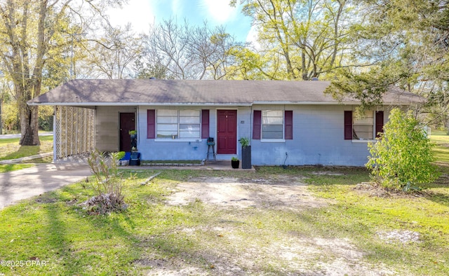 540 4th St, Chipley, FL 32428 - ranch-style home with concrete block siding, a carport, a front lawn, and driveway
