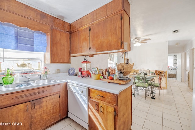 540 4th St, Chipley, FL 32428 - kitchen with dishwasher, light tile patterned flooring, light countertops, ceiling fan, and brown cabinets