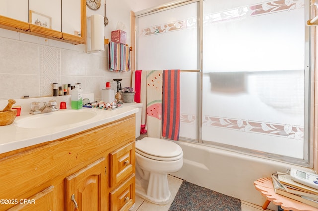 540 4th St, Chipley, FL 32428 - full bath with vanity, toilet, combined bath / shower with glass door, tile patterned floors, and tasteful backsplash