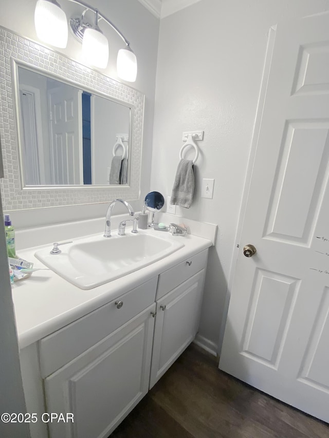 1025 W 19th St Unit 2D, Panama City, FL 32405 - bathroom featuring vanity, wood finished floors, and crown molding