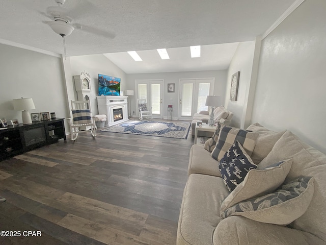 1025 W 19th St Unit 2D, Panama City, FL 32405 - living area with lofted ceiling, wood finished floors, a lit fireplace, ceiling fan, and ornamental molding