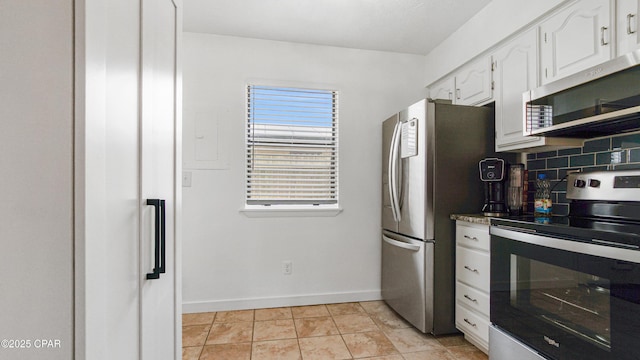612 Laurel St Unit D, Panama City Beach, FL 32407 - kitchen featuring appliances with stainless steel finishes, white cabinetry, baseboards, and backsplash
