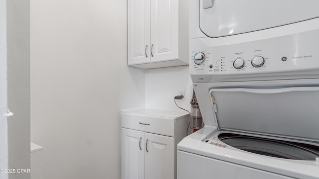 612 Laurel St Unit D, Panama City Beach, FL 32407 - laundry room featuring stacked washer / drying machine and cabinet space