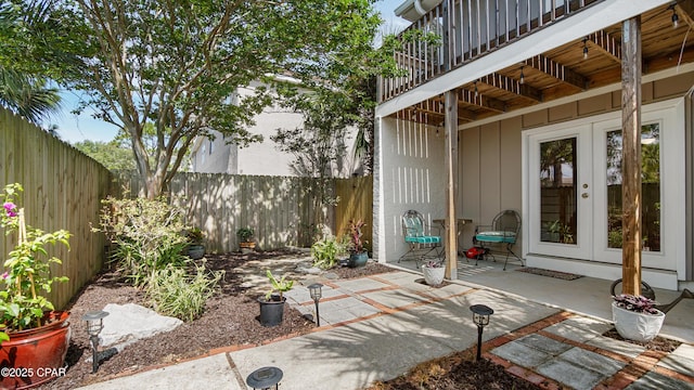 612 Laurel St Unit D, Panama City Beach, FL 32407 - fenced backyard featuring french doors, a patio area, and a balcony