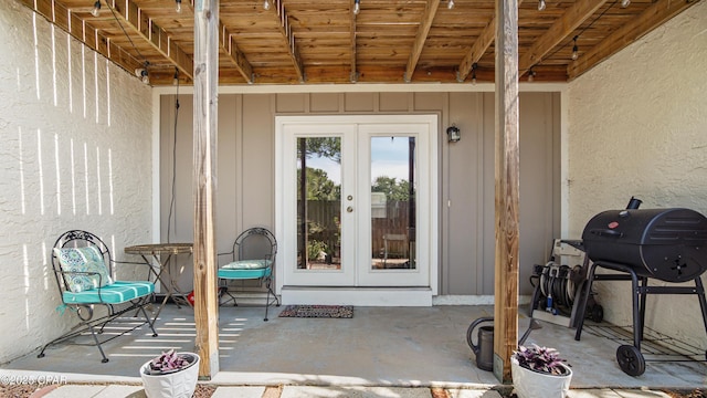 612 Laurel St Unit D, Panama City Beach, FL 32407 - view of exterior entry with french doors, board and batten siding, and a patio