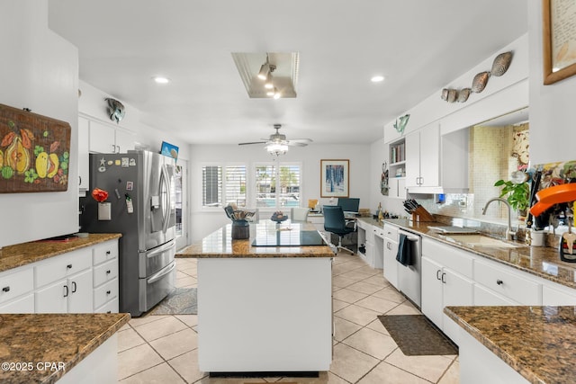 1110 Redfish Cir, Panama City, FL 32408 - kitchen featuring appliances with stainless steel finishes, a kitchen island, white cabinets, a sink, and ceiling fan