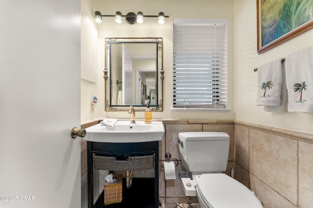 1110 Redfish Cir, Panama City, FL 32408 - half bath with toilet, tile walls, vanity, and a wainscoted wall