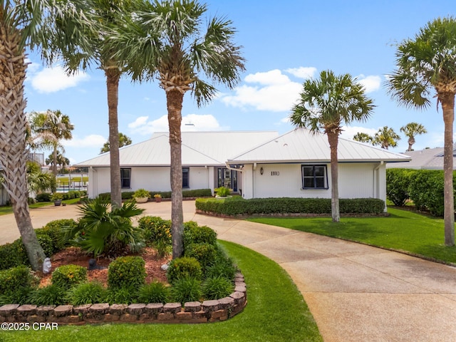 1110 Redfish Cir, Panama City, FL 32408 - single story home featuring curved driveway, a front lawn, and metal roof