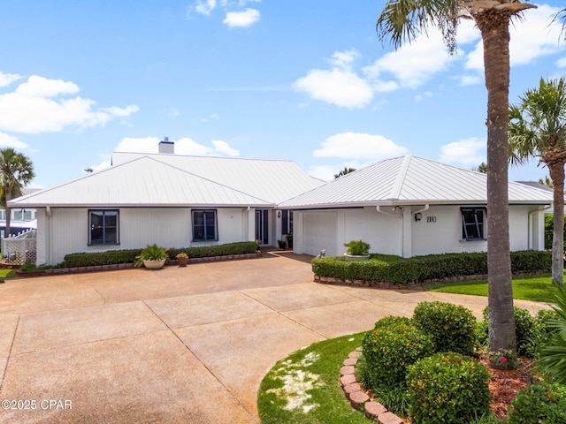 1110 Redfish Cir, Panama City, FL 32408 - single story home with driveway, a garage, metal roof, a chimney, and a standing seam roof