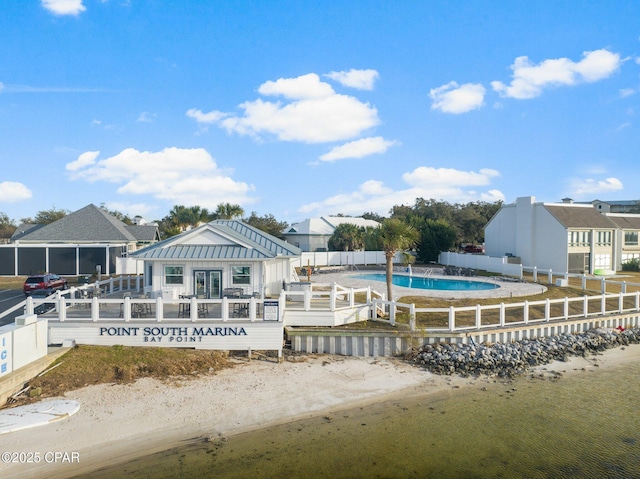 1110 Redfish Cir, Panama City, FL 32408 - back of house featuring a community pool, metal roof, and a standing seam roof