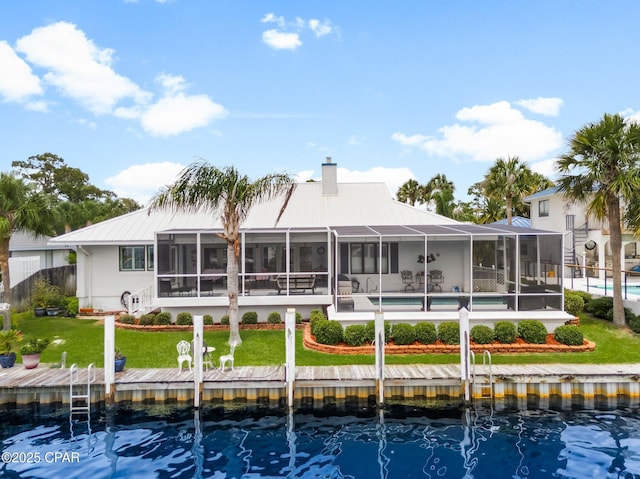 1110 Redfish Cir, Panama City, FL 32408 - back of property with metal roof, an outdoor pool, a chimney, and a lanai