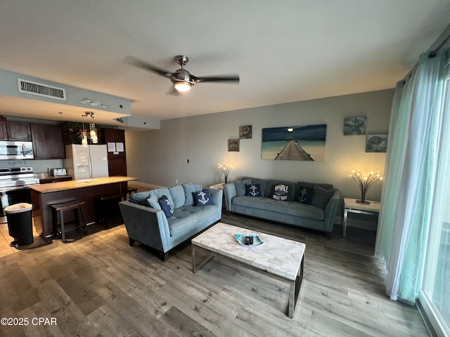 9902 S Thomas Dr Unit 636, Panama City Beach, FL 32408 - living room featuring light wood-style flooring and a ceiling fan