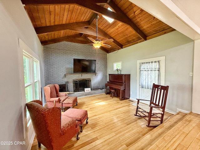 5382 10th St, Malone, FL 32445 - living room featuring plenty of natural light, light wood finished floors, a fireplace, brick wall, and wood ceiling