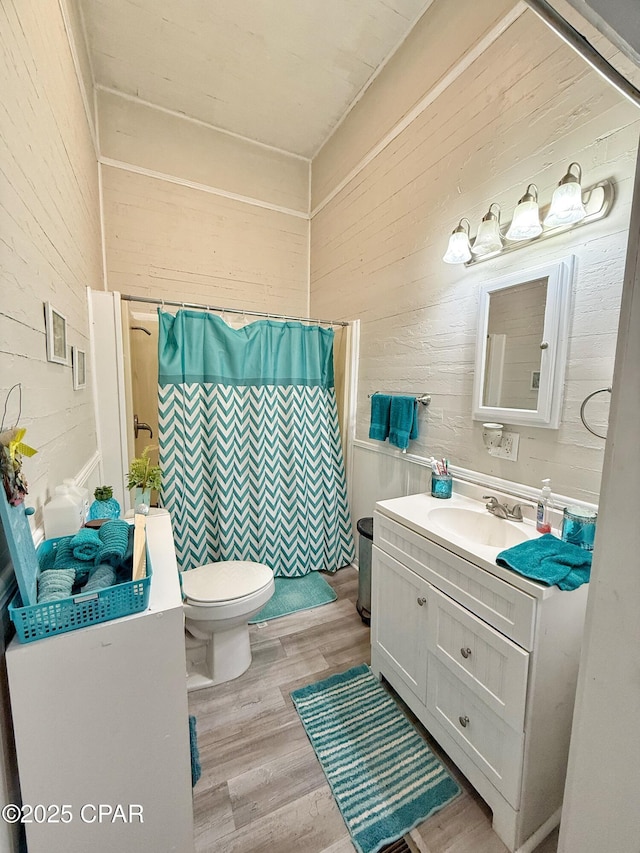 5382 10th St, Malone, FL 32445 - bathroom with wooden walls, vanity, wood finished floors, and a shower with curtain