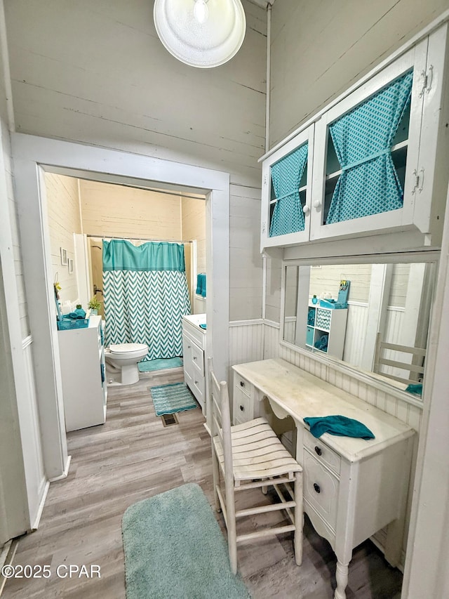 5382 10th St, Malone, FL 32445 - bedroom featuring light wood finished floors, ensuite bathroom, and wooden walls
