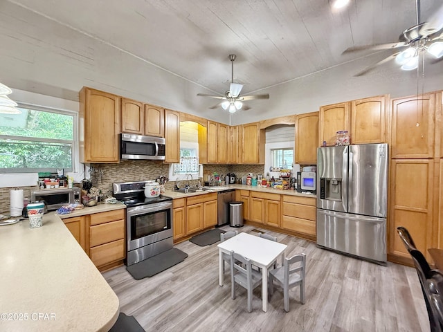 5382 10th St, Malone, FL 32445 - kitchen with appliances with stainless steel finishes, ceiling fan, light countertops, and decorative backsplash