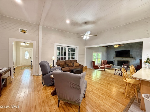 5382 10th St, Malone, FL 32445 - living room with a ceiling fan, a fireplace, and light wood finished floors