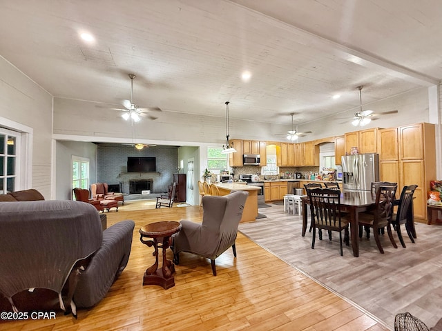 5382 10th St, Malone, FL 32445 - living room featuring a ceiling fan, light wood finished floors, and a fireplace