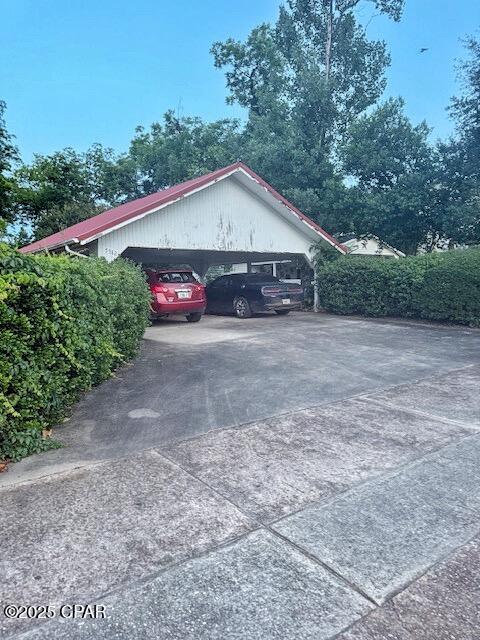 5382 10th St, Malone, FL 32445 - view of vehicle parking featuring driveway and a carport