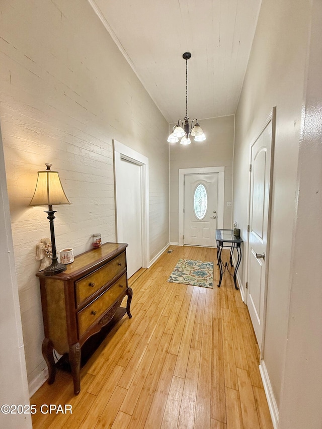 5382 10th St, Malone, FL 32445 - entryway with light wood-style floors and a chandelier