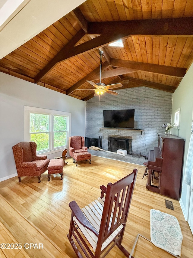 5382 10th St, Malone, FL 32445 - living area with light wood finished floors, a fireplace, wood ceiling, and a ceiling fan