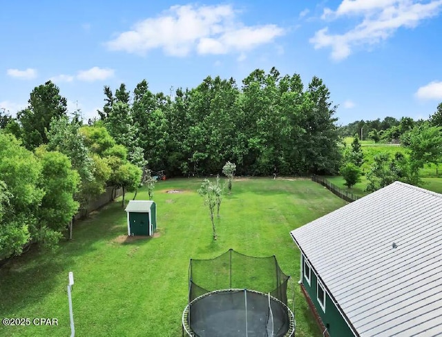 21382 NW Paradise Ln, Altha, FL 32421 - view of yard with a trampoline and view of wooded area