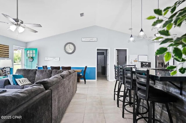 21382 NW Paradise Ln, Altha, FL 32421 - living area featuring ceiling fan, vaulted ceiling, light tile patterned floors, and baseboards