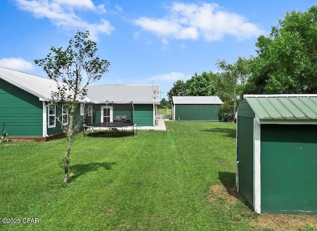21382 NW Paradise Ln, Altha, FL 32421 - view of green lawn with a trampoline