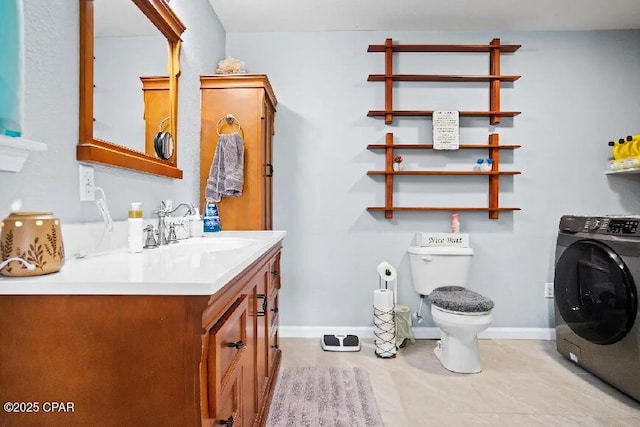 21382 NW Paradise Ln, Altha, FL 32421 - bathroom featuring washer / dryer, vanity, toilet, and baseboards