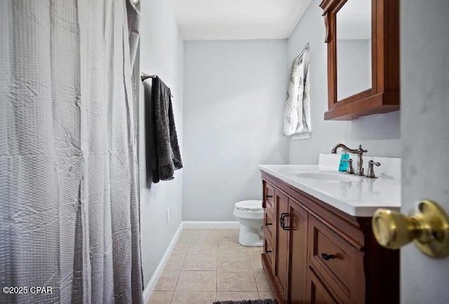 21382 NW Paradise Ln, Altha, FL 32421 - bathroom with toilet, vanity, tile patterned flooring, and baseboards