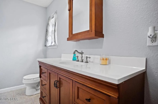 21382 NW Paradise Ln, Altha, FL 32421 - bathroom featuring vanity, toilet, tile patterned floors, and baseboards