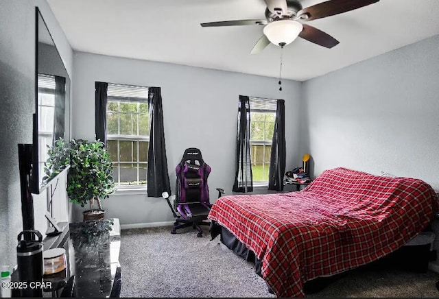 21382 NW Paradise Ln, Altha, FL 32421 - carpeted bedroom featuring multiple windows, ceiling fan, and baseboards