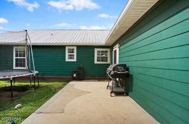 21382 NW Paradise Ln, Altha, FL 32421 - view of patio with a trampoline and grilling area