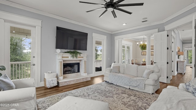 24197 NW Pine Tree Trl, Fountain, FL 32438 - living room featuring ornamental molding, ornate columns, a ceiling fan, wood finished floors, and a fireplace