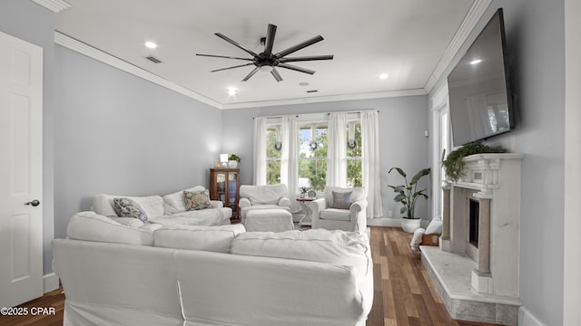 24197 NW Pine Tree Trl, Fountain, FL 32438 - living room featuring crown molding, a ceiling fan, recessed lighting, wood finished floors, and a premium fireplace
