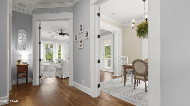 24197 NW Pine Tree Trl, Fountain, FL 32438 - hall featuring wood-type flooring, crown molding, and decorative columns
