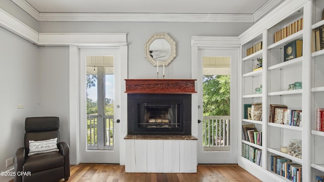 24197 NW Pine Tree Trl, Fountain, FL 32438 - sitting room with ornamental molding, wood finished floors, and a fireplace with raised hearth