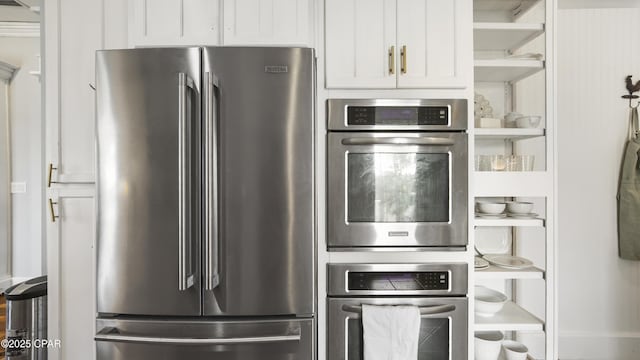24197 NW Pine Tree Trl, Fountain, FL 32438 - kitchen with stainless steel appliances, open shelves, and white cabinets