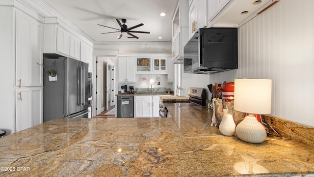 24197 NW Pine Tree Trl, Fountain, FL 32438 - kitchen featuring stainless steel appliances, a ceiling fan, white cabinets, glass insert cabinets, and crown molding