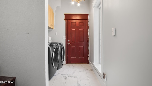 24197 NW Pine Tree Trl, Fountain, FL 32438 - washroom featuring washer and dryer, light marble finish flooring, and cabinet space