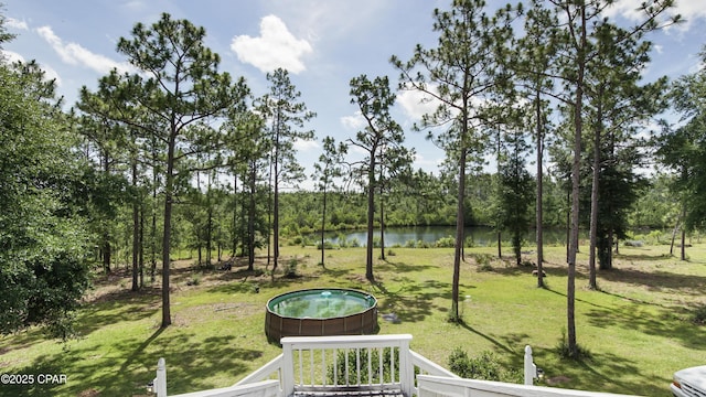 24197 NW Pine Tree Trl, Fountain, FL 32438 - view of green lawn with a jacuzzi and a water view