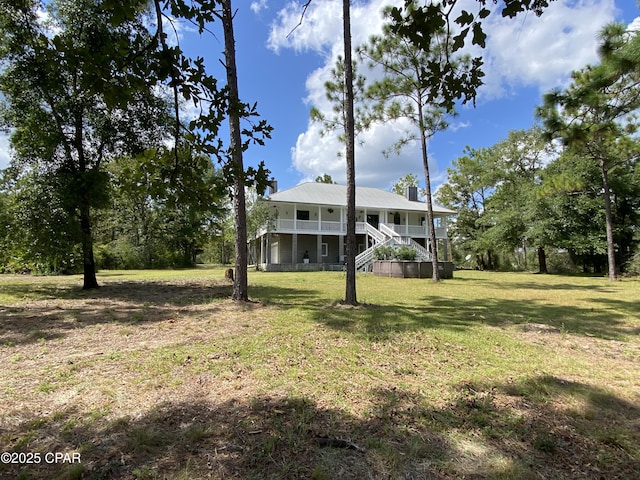 24197 NW Pine Tree Trl, Fountain, FL 32438 - view of front of property with stairway and a front yard