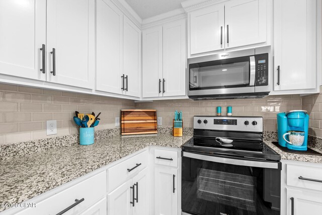 4304 Bylsma Cir, Panama City, FL 32404 - kitchen with stainless steel appliances, white cabinetry, decorative backsplash, and light stone countertops