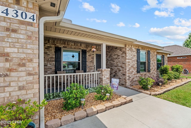 4304 Bylsma Cir, Panama City, FL 32404 - doorway to property featuring covered porch and brick siding