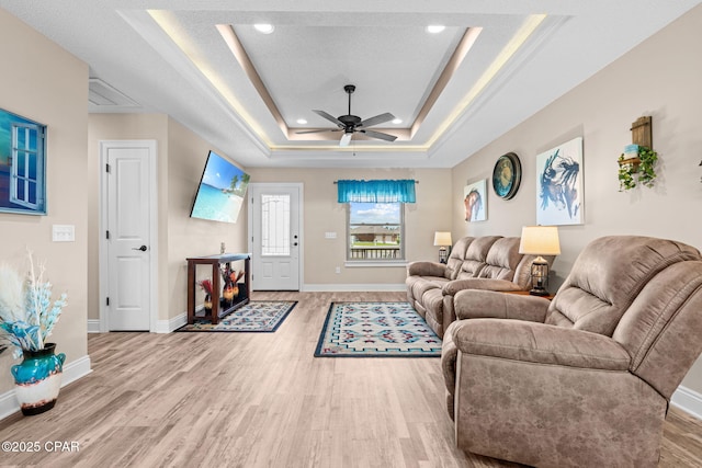 4304 Bylsma Cir, Panama City, FL 32404 - living area with a raised ceiling, wood finished floors, ceiling fan, baseboards, and recessed lighting
