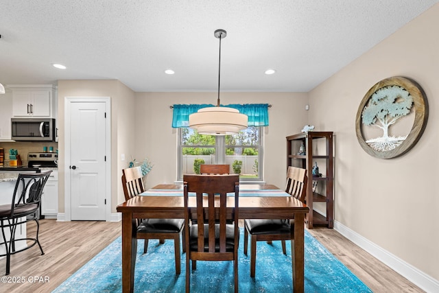 4304 Bylsma Cir, Panama City, FL 32404 - dining room featuring light wood-type flooring, baseboards, a textured ceiling, and recessed lighting