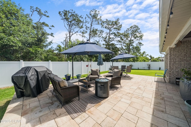 2012 Frankford Point Rd, Panama City, FL 32405 - fenced backyard featuring a patio area, an outdoor living space with a fire pit, a grill, and outdoor dining space